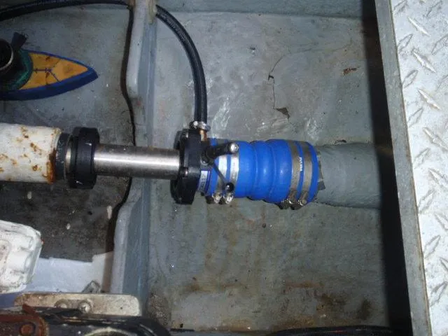 Slide: The Image of 1999 Sea Ray 410 Express Cruiser engine compartment with blue hose and metal fittings. - 35