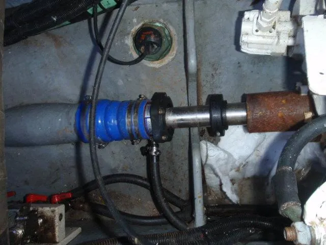 Slide: The Image of Engine compartment of 1999 Sea Ray 410 Express Cruiser, showing mechanical components and hoses. - 36