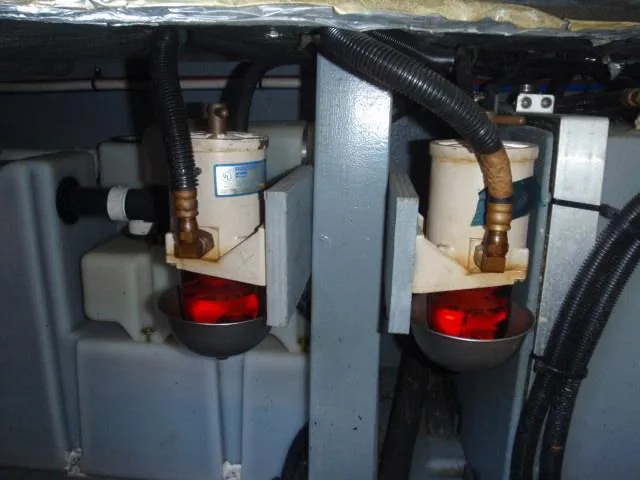 Slide: The Image of Fuel filters in the engine room of a 1999 Sea Ray 410 Express Cruiser. - 38