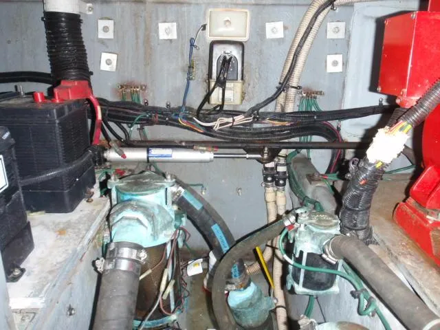 Slide: The Image of Engine room of 1999 Sea Ray 410 Express Cruiser with wiring and mechanical components. - 39