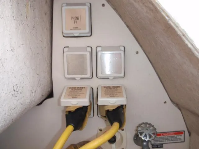 Slide: The Image of Electrical and communication outlets on a 1999 Sea Ray 410 Express Cruiser. - 40