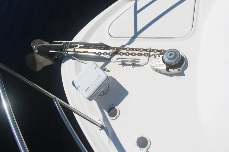 Slide: The Image of Anchor and chain on 1999 Sea Ray 410 Express Cruiser deck. - 46