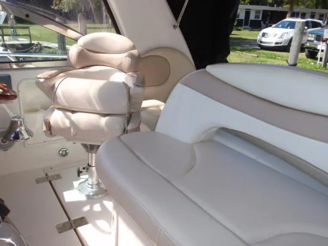 Slide: The Image of 1999 Sea Ray 410 Express Cruiser interior with plush seating and helm chair. - 5