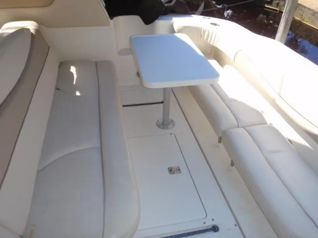 Slide: The Image of 1999 Sea Ray 410 Express Cruiser interior with white seating and table. - 6