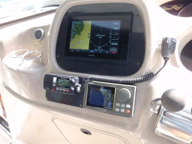 Slide: The Image of 1999 Sea Ray 410 Express Cruiser dashboard with navigation and communication equipment. - 7