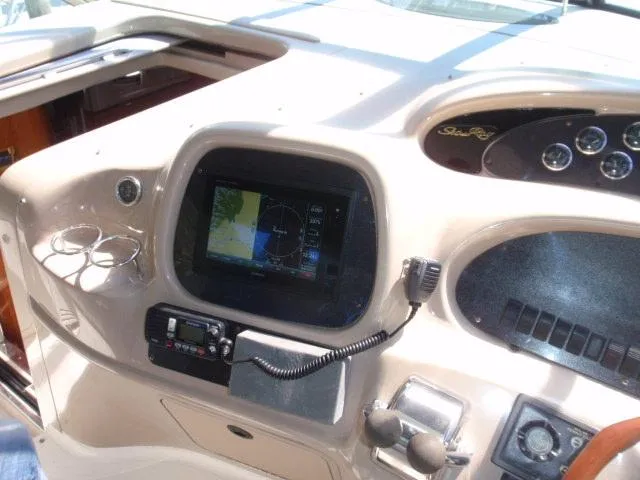 Slide: The Image of 1999 Sea Ray 410 Express Cruiser dashboard with navigation system and controls. - 8