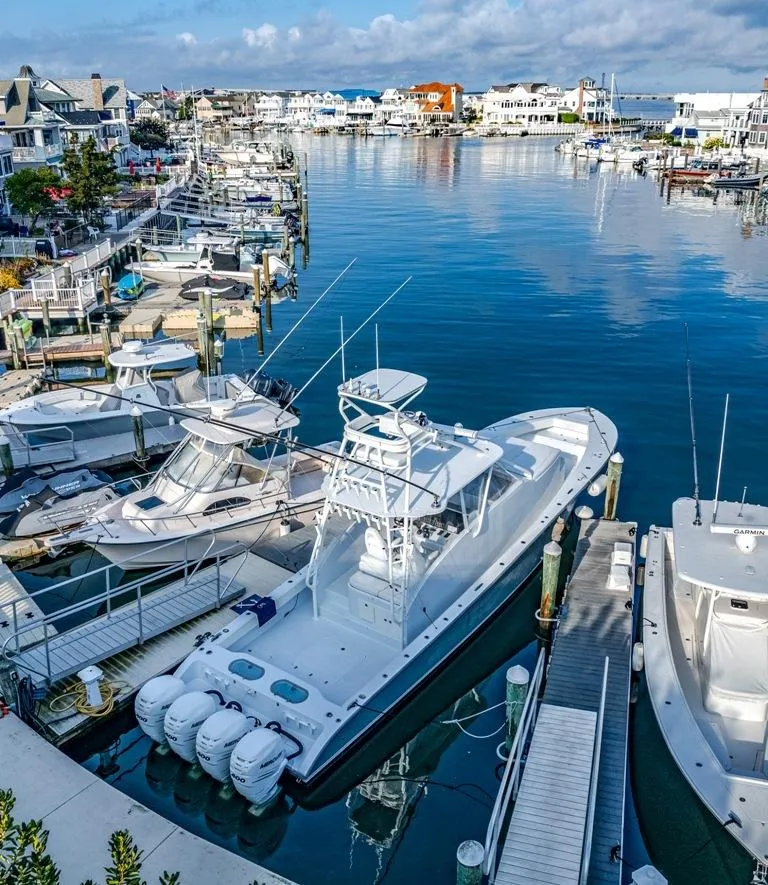 Slide: The Image of Aerial view of a 2021 Conch 47 boat docked in a scenic marina. - 19