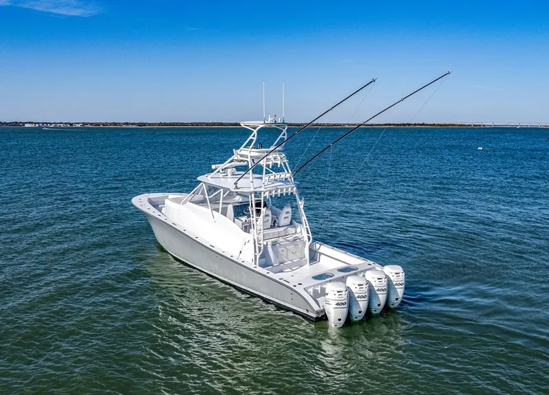 Slide: The Image of 2021 Conch 47 boat with four engines on open water under clear blue sky. - 2