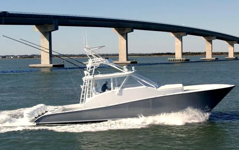 Slide: The Image of 2021 Conch 47 boat cruising under a bridge on a sunny day. - 3