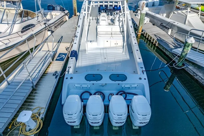 Slide: The Image of 2021 Conch 47 boat with quad 400 engines docked at marina. - 31