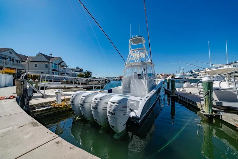 Slide: The Image of 2021 Conch 47 boat docked at marina with four powerful engines. - 33