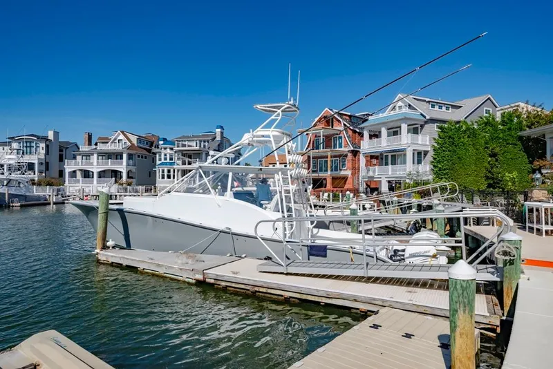 Slide: The Image of 2021 Conch 47 boat docked in a marina with waterfront homes. - 34