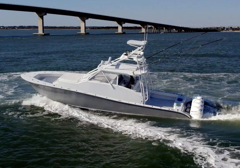 Slide: The Image of 2021 Conch 47 boat cruising under a bridge on open water. - 4