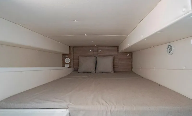 Slide: The Image of Interior cabin of 2021 Conch 47 boat with cozy bedding and pillows. - 43