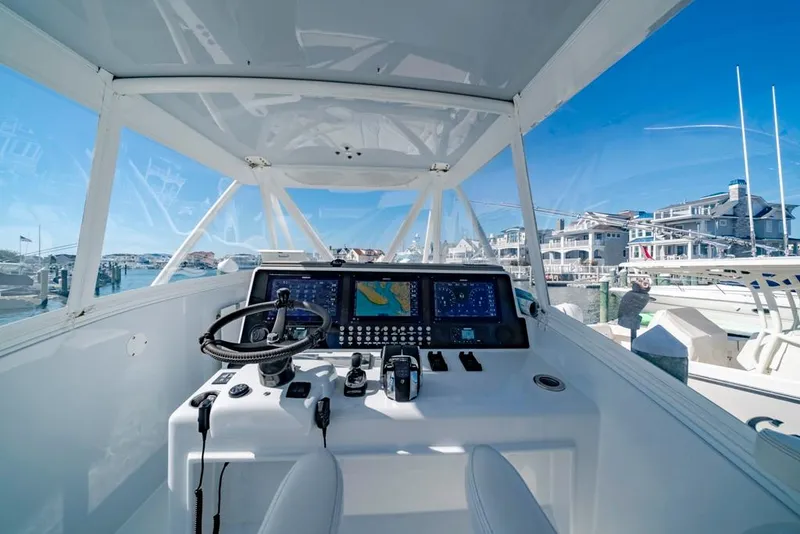 Slide: The Image of 2021 Conch 47 boat cockpit with advanced navigation system and steering wheel. - 46