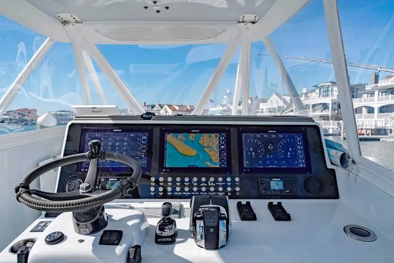 Slide: The Image of Helm of 2021 Conch 47 boat with advanced navigation displays and controls. - 48