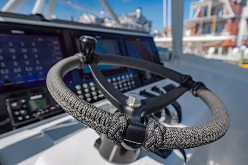 Slide: The Image of Steering wheel of 2021 Conch 47 boat with advanced navigation displays. - 49