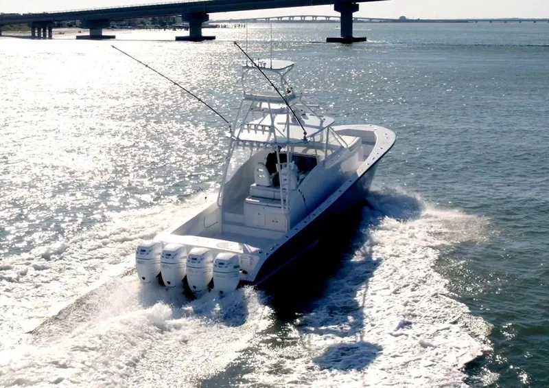 Slide: The Image of 2021 Conch 47 boat cruising on water with bridge in background. - 6