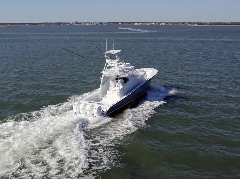 Slide: The Image of A 2021 Conch 47 boat cruising on open water, showcasing powerful engines and sleek design. - 7