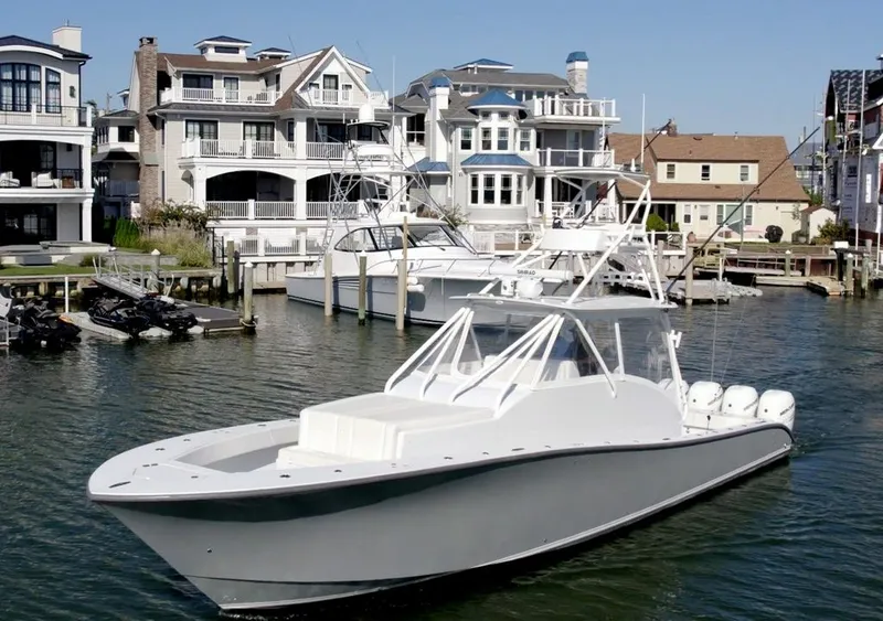 Slide: The Image of 2021 Conch 47 boat docked near luxury waterfront homes. - 9