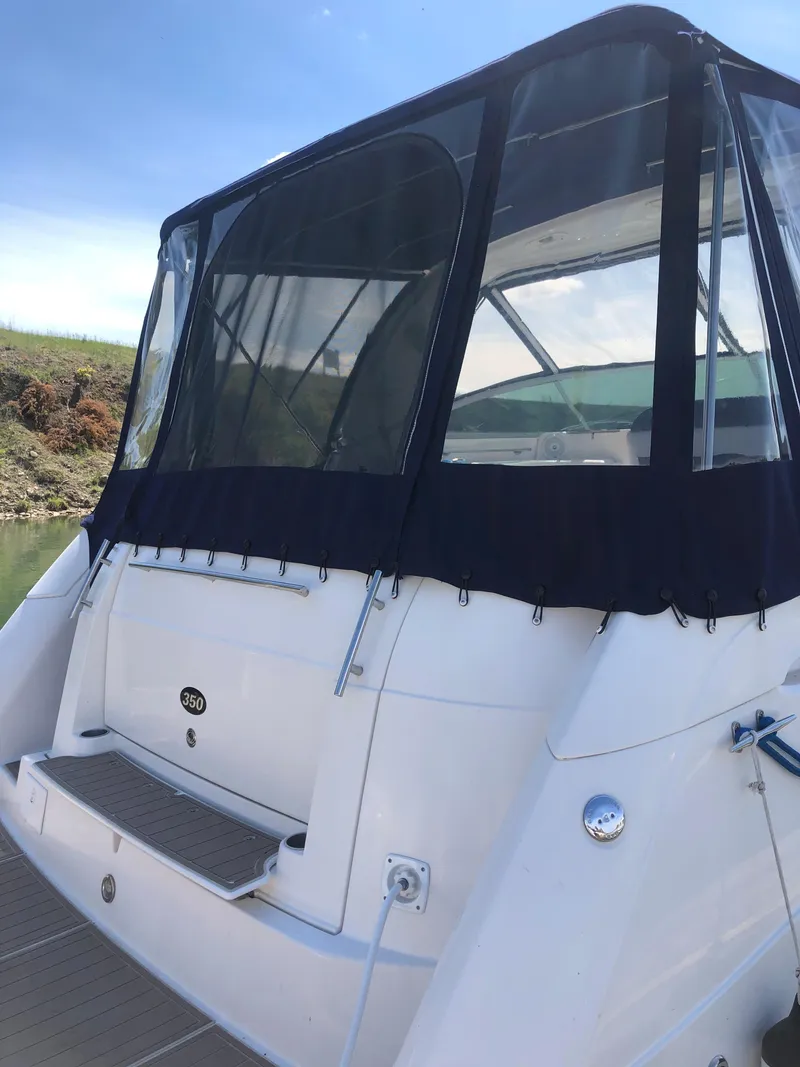Slide: The Image of 2007 Rinker 350 Express Cruiser with black canopy, rear view. - 12