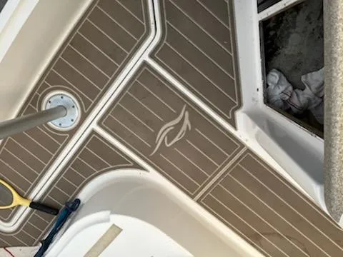 Slide: The Image of 2007 Rinker 350 Express Cruiser deck with wood-like flooring and storage compartment. - 18