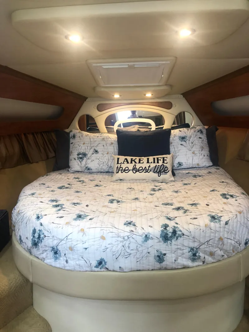 Slide: The Image of Cozy cabin interior of 2007 Rinker 350 Express Cruiser with floral bedding and decorative pillow. - 4
