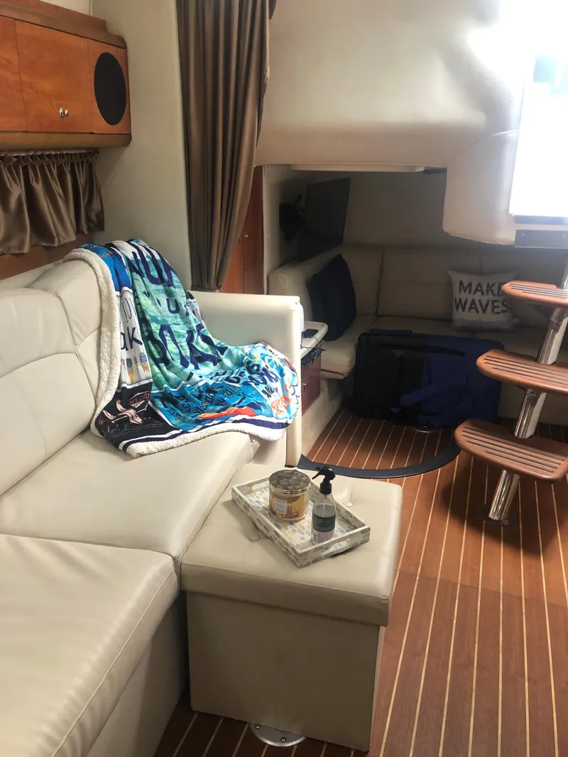 Slide: The Image of Interior of 2007 Rinker 350 Express Cruiser with cozy seating and wooden flooring. - 8
