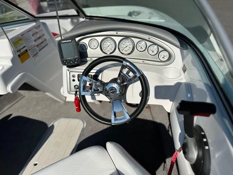 Slide: The Image of 2015 Ebbtide 176 SE Bow Rider dashboard with steering wheel and gauges. - 4