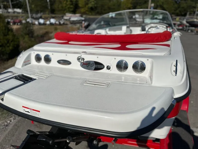 Slide: The Image of 2015 Ebbtide 176 SE Bow Rider boat with red and white interior, rear view. - 9