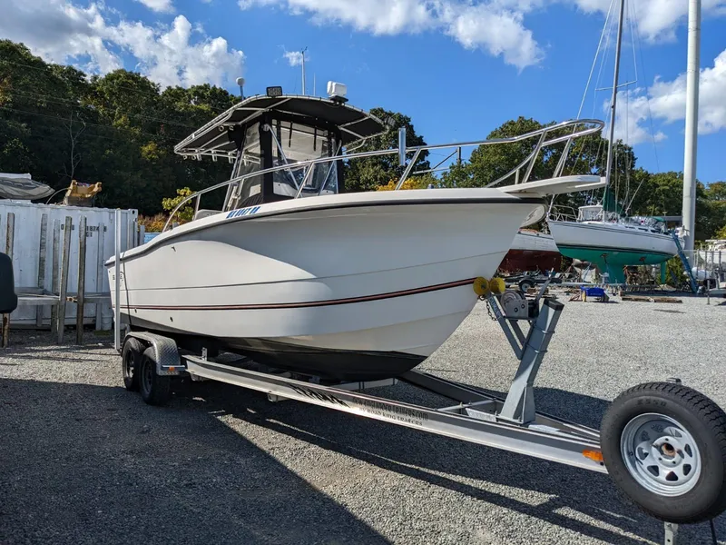 Slide: The Image of 2007 Sea Boss 235 Center Console boat on trailer, parked outdoors under blue sky. - 0