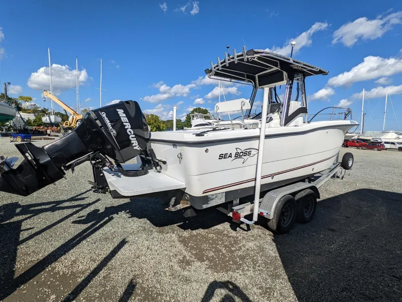 Slide: The Image of 2007 Sea Boss 235 Center Console boat on trailer, featuring Mercury outboard motor. - 1