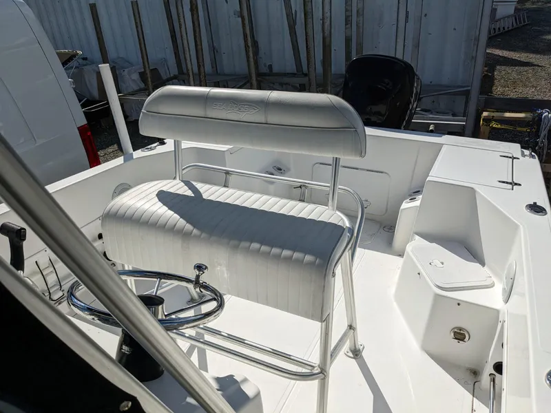 Slide: The Image of 2007 Sea Boss 235 Center Console boat interior with white seating and steering wheel. - 10