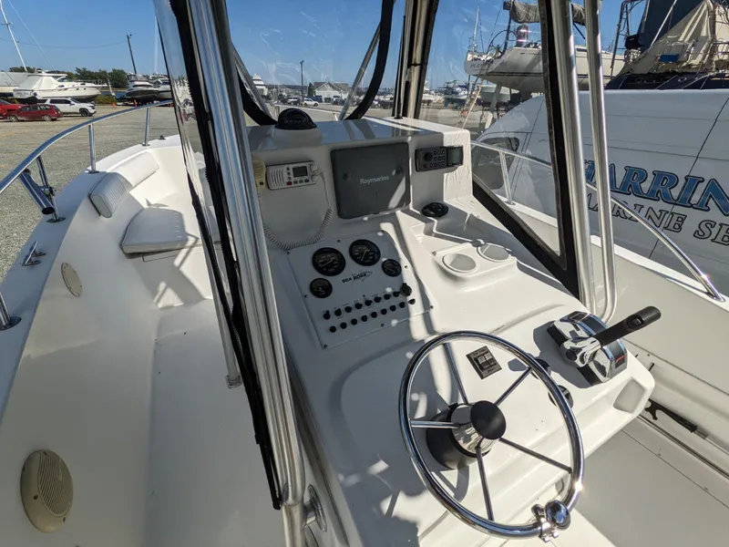 Slide: The Image of 2007 Sea Boss 235 Center Console boat dashboard with steering wheel and navigation equipment. - 11