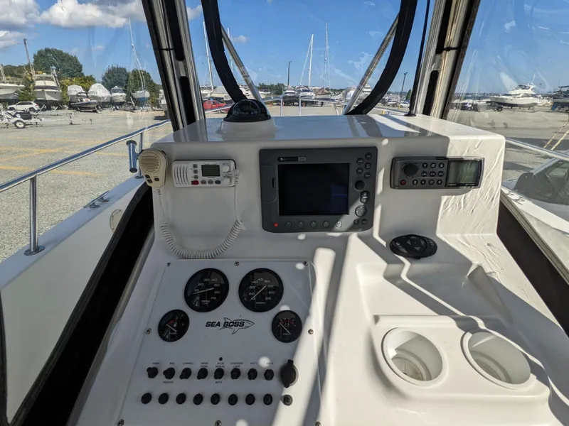 Slide: The Image of 2007 Sea Boss 235 Center Console dashboard with navigation and control instruments. - 12