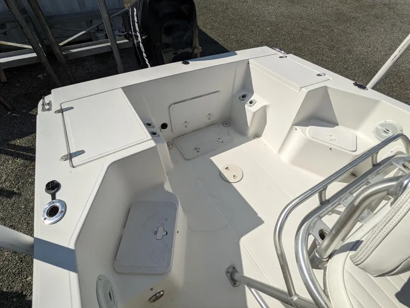 Slide: The Image of 2007 Sea Boss 235 Center Console boat interior, featuring spacious seating and storage compartments. - 13