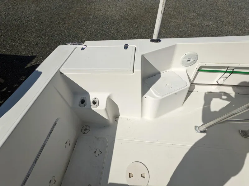 Slide: The Image of 2007 Sea Boss 235 Center Console boat interior, featuring seating and storage compartments. - 15