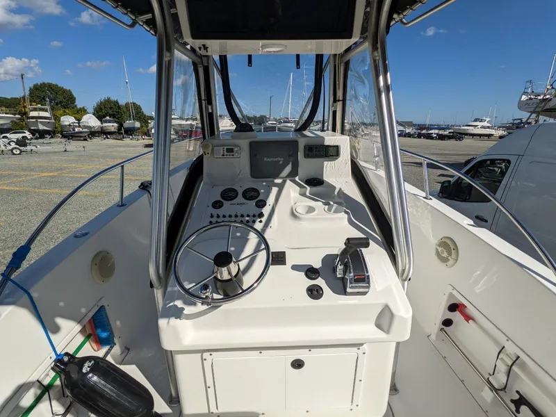 Slide: The Image of 2007 Sea Boss 235 Center Console boat interior with steering wheel and control panel. - 6