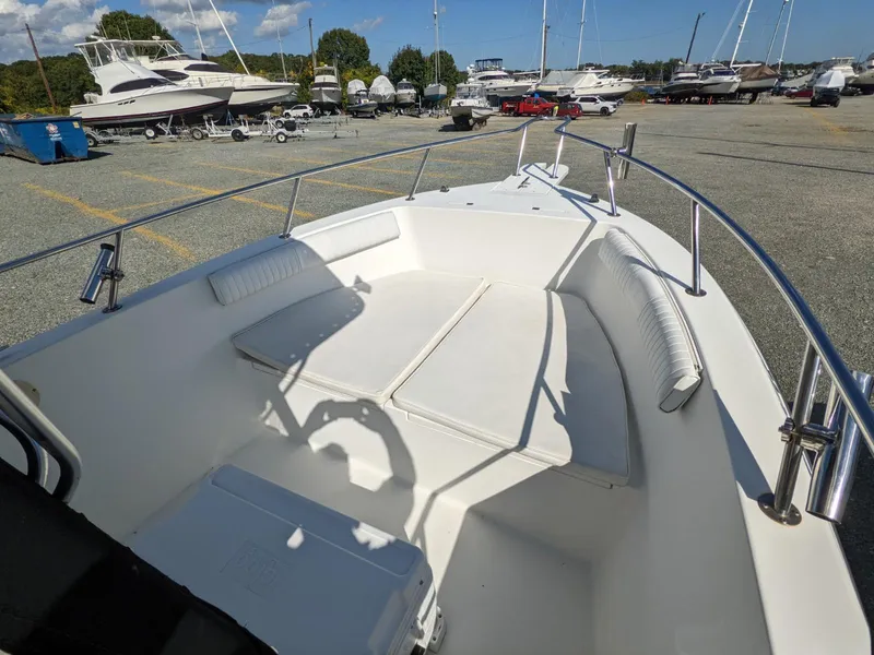 Slide: The Image of 2007 Sea Boss 235 Center Console boat, docked with spacious seating area. - 8