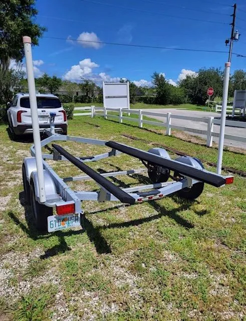 Slide: The Image of Boat trailer for 2021 Bayliner VR6 Bowrider OB parked on grass. - 13