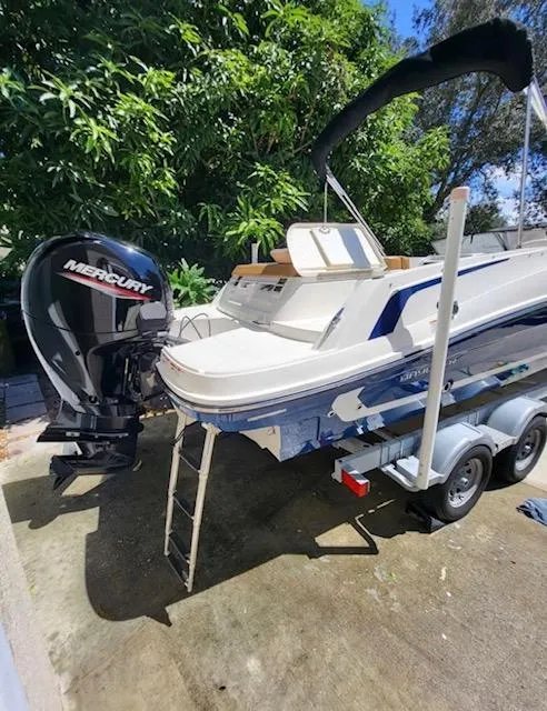 Slide: The Image of 2021 Bayliner VR6 Bowrider OB with Mercury outboard engine on trailer. - 2