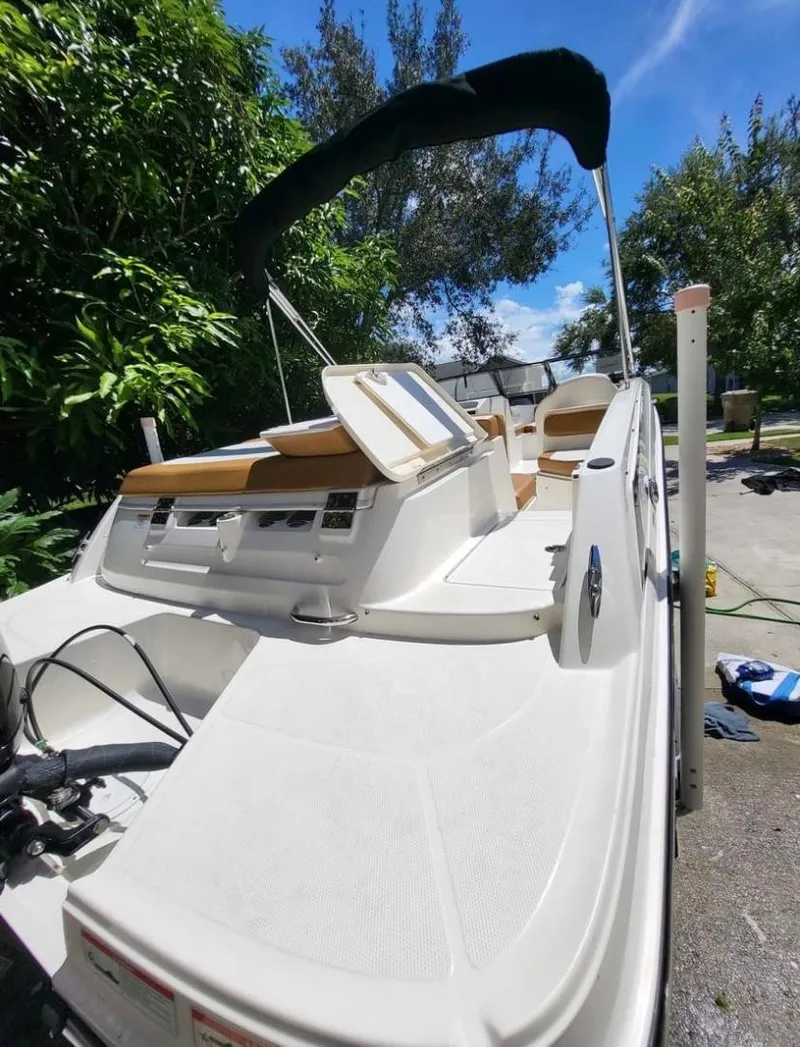 Slide: The Image of 2021 Bayliner VR6 Bowrider OB boat with canopy in a sunny outdoor setting. - 4