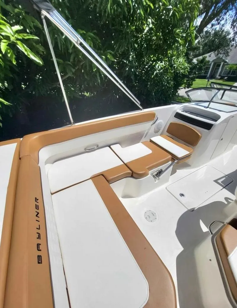 Slide: The Image of 2021 Bayliner VR6 Bowrider OB interior with tan and white seating. - 5