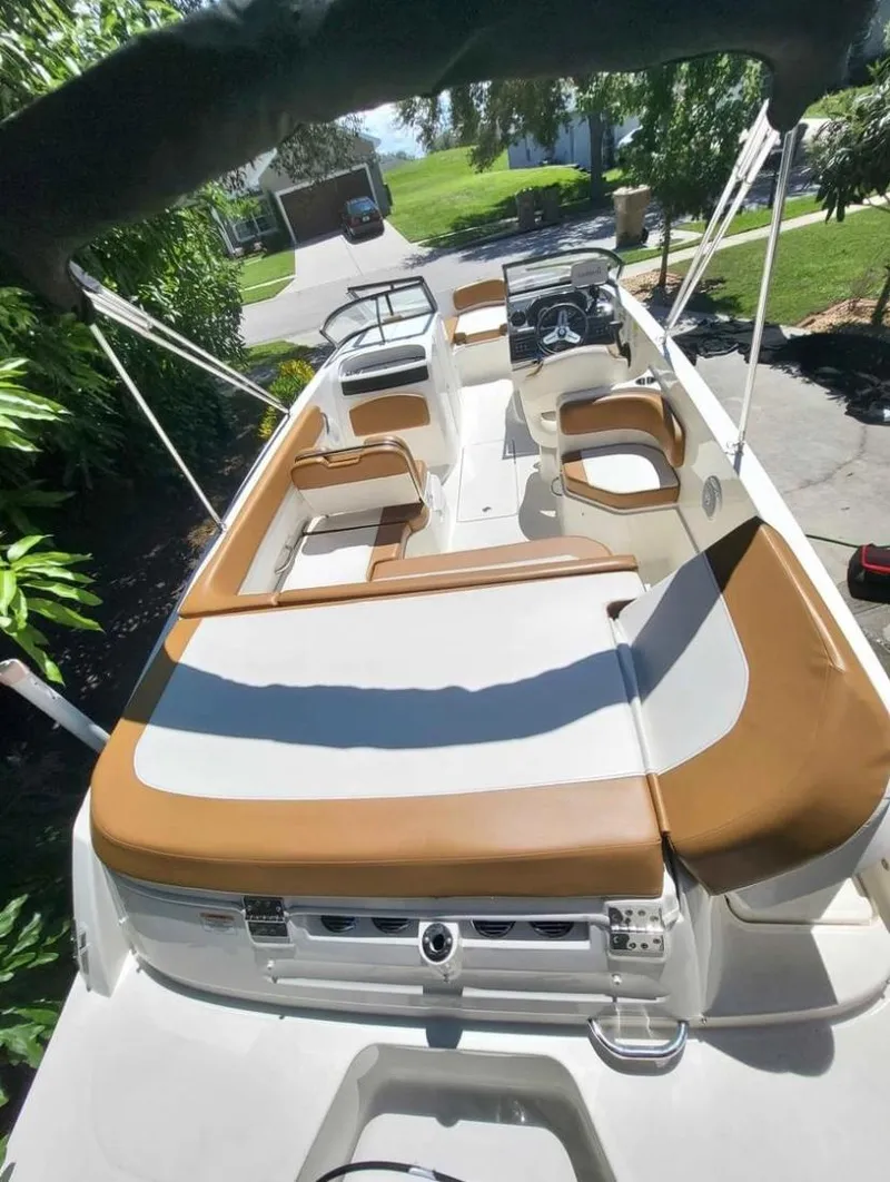 Slide: The Image of 2021 Bayliner VR6 Bowrider OB with tan and white seating, docked outdoors. - 7