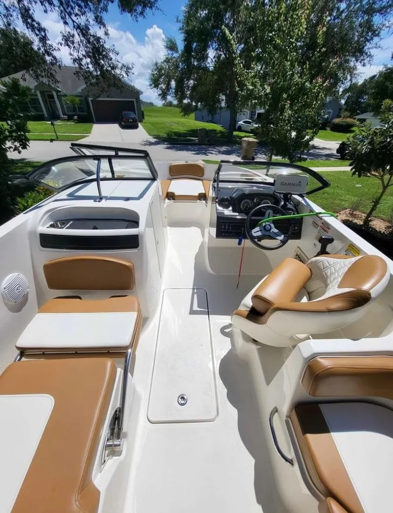 Slide: The Image of 2021 Bayliner VR6 Bowrider OB interior with tan and white seating. - 8