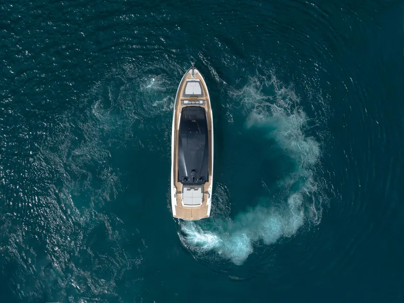 Slide: The Image of Aerial view of 2023 Astondoa 677 Coupe yacht cruising in clear blue waters. - 11
