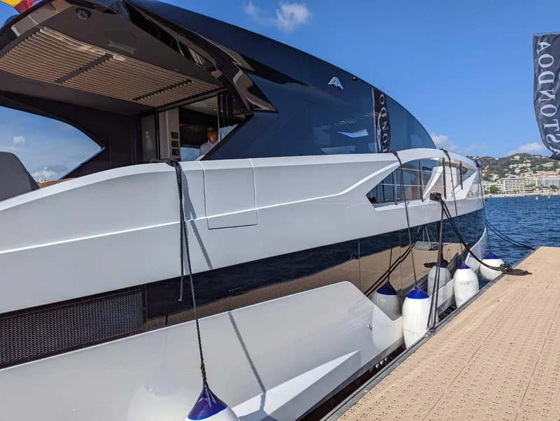 Slide: The Image of 2023 Astondoa 677 Coupe yacht docked at marina, sleek design, sunny day. - 14