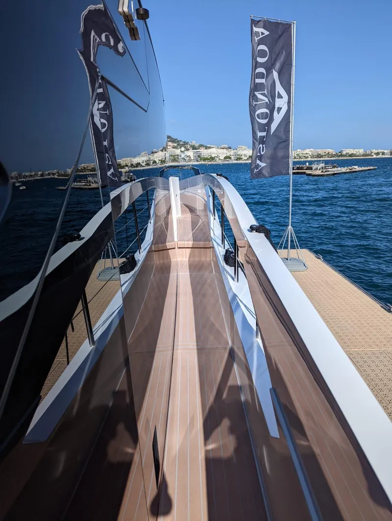 Slide: The Image of 2023 Astondoa 677 Coupe yacht docked with reflection on water. - 16
