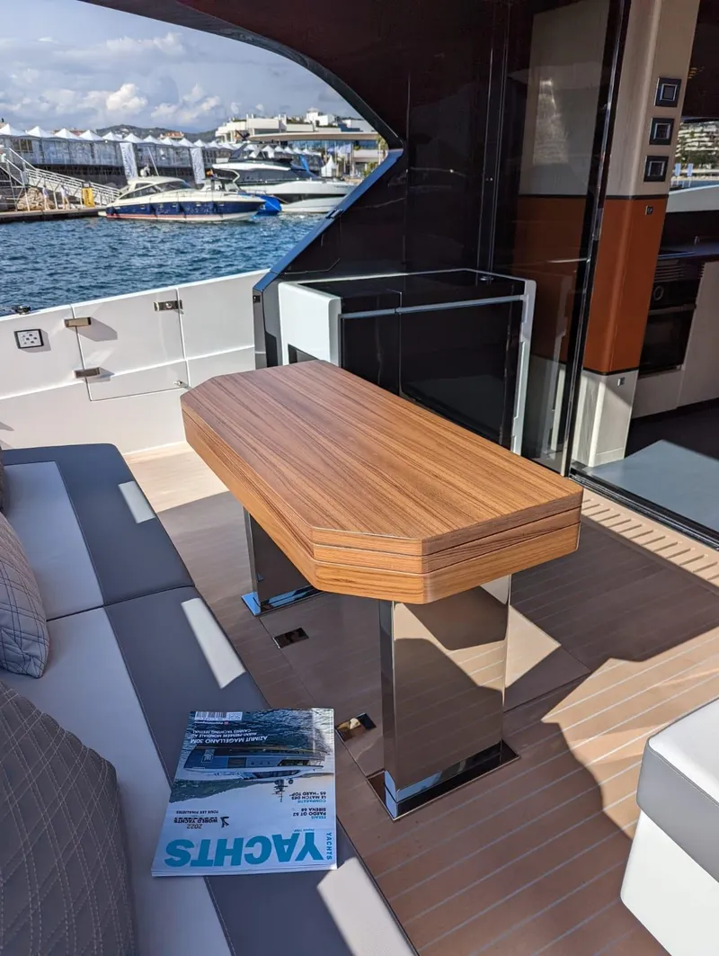 Slide: The Image of Luxury Astondoa 677 Coupe yacht interior, featuring sleek wooden table, 2023 model. - 17