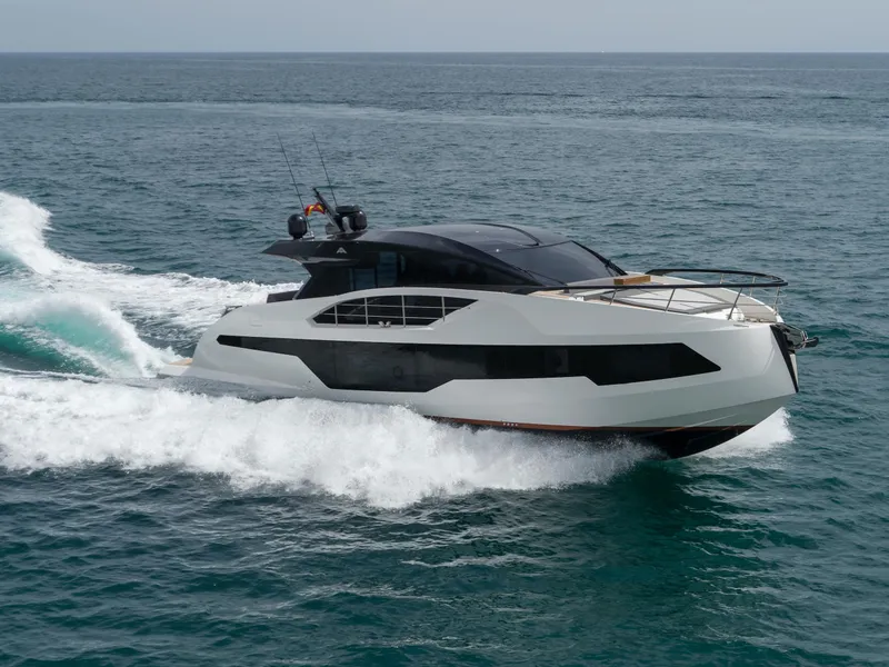 Slide: The Image of 2023 Astondoa 677 Coupe yacht cruising on open water. - 2